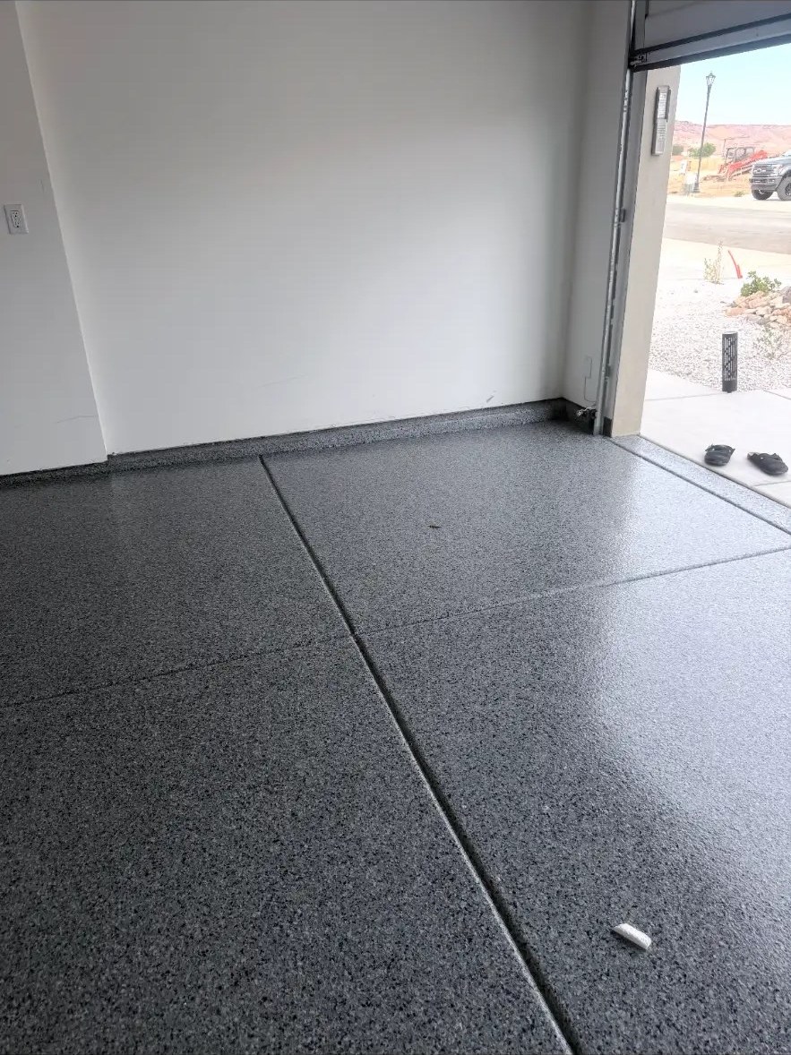 Gray flake floor next to an open garage door