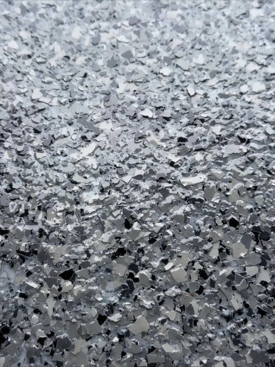 Close up of black, white, and gray flake blend