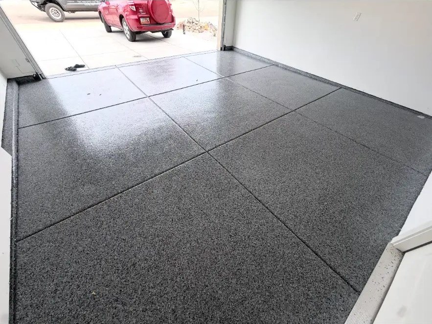 Deep gray flake garage floor with car outside