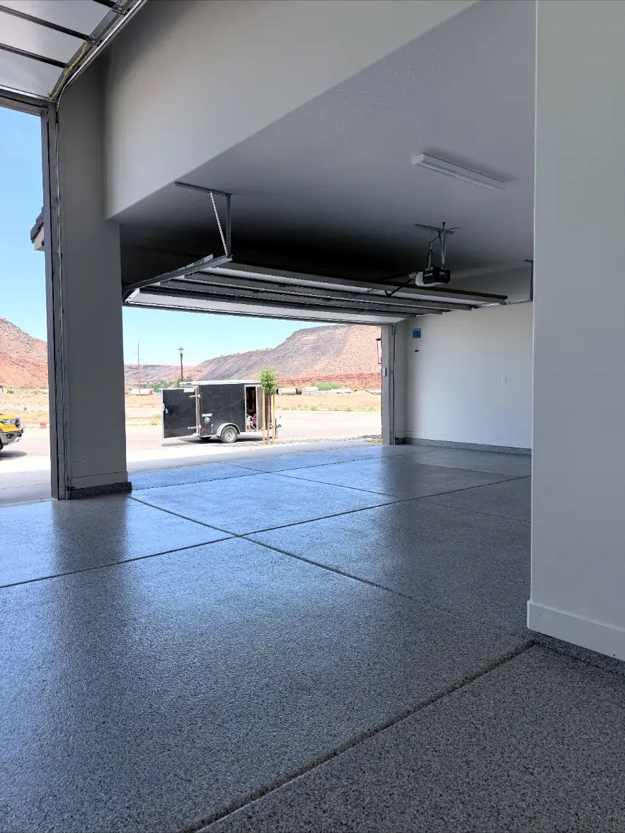 Open garage with flake floor and desert mountain view