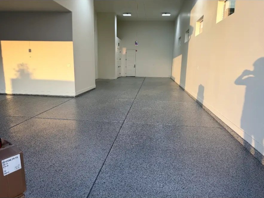 Spacious garage interior with gray flake floor