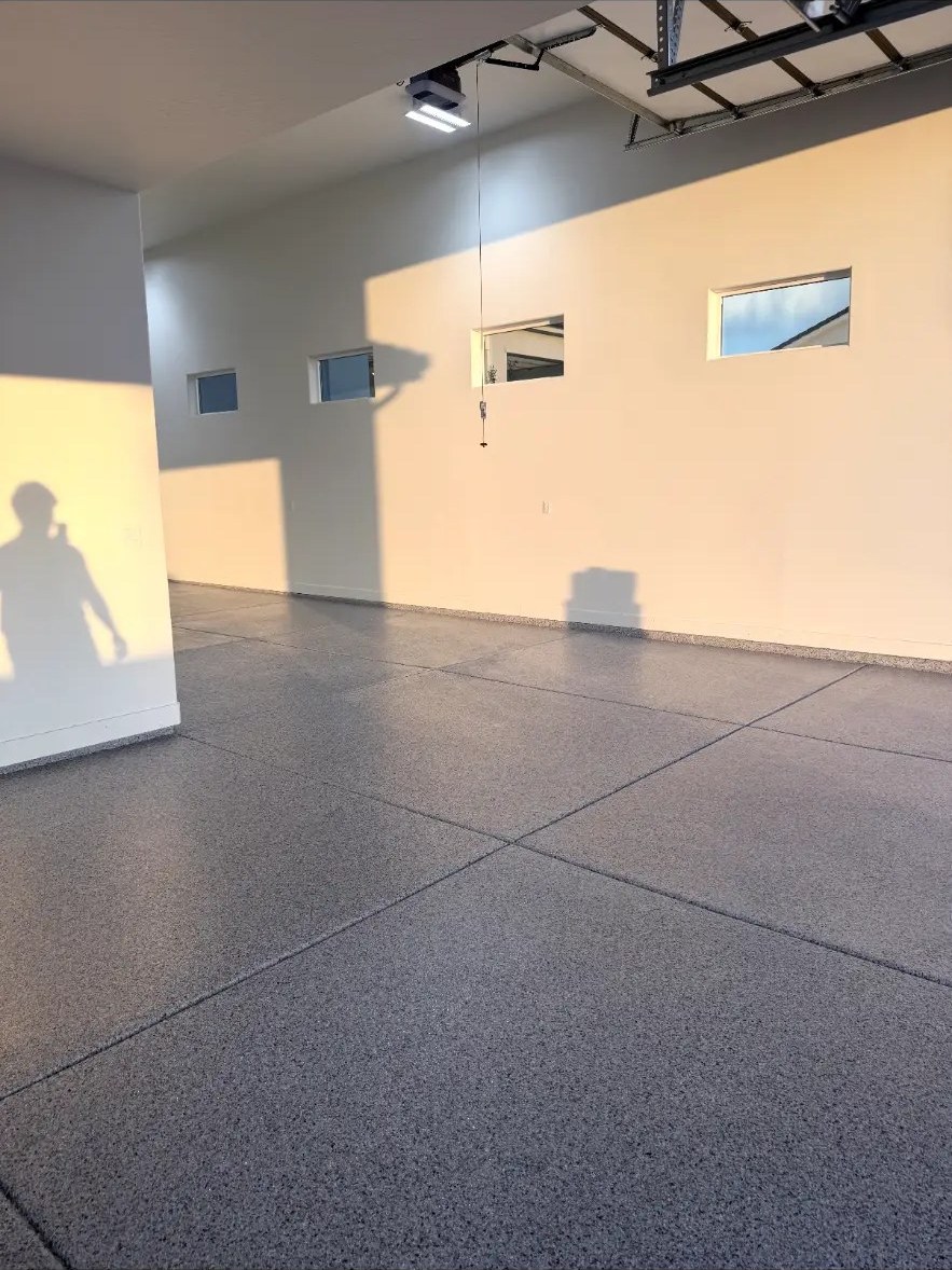 Large garage with flake floor and sunset light