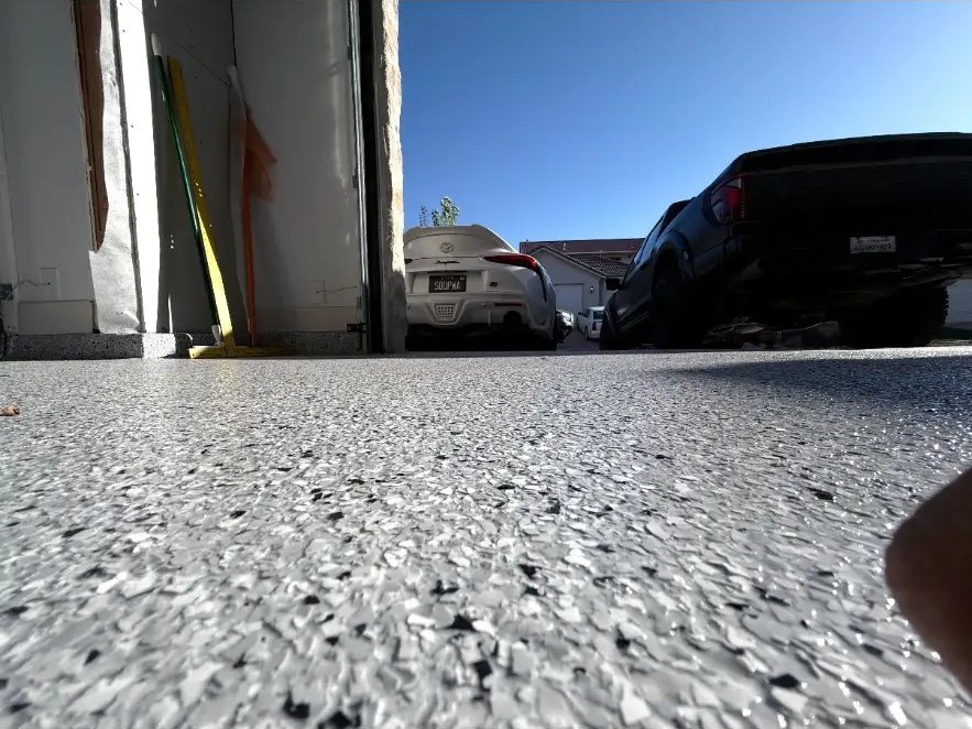 Low angle of flake floor with cars parked outside
