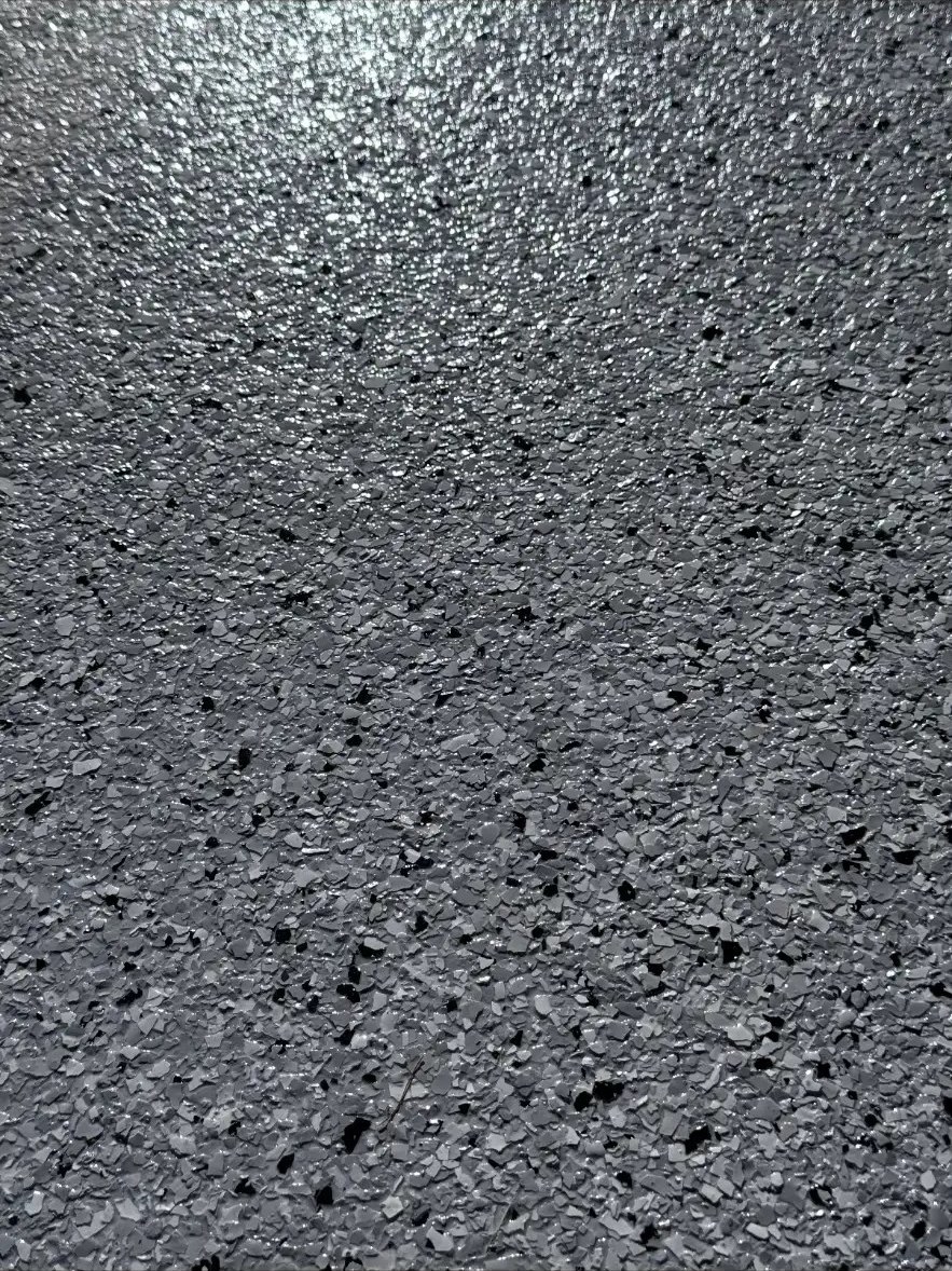Close up of glossy black and gray flake finish